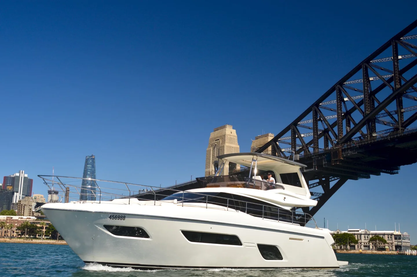 The Ribbon, a Ferretti 550 motor yacht, cruising beneath the Sydney Harbour Bridge